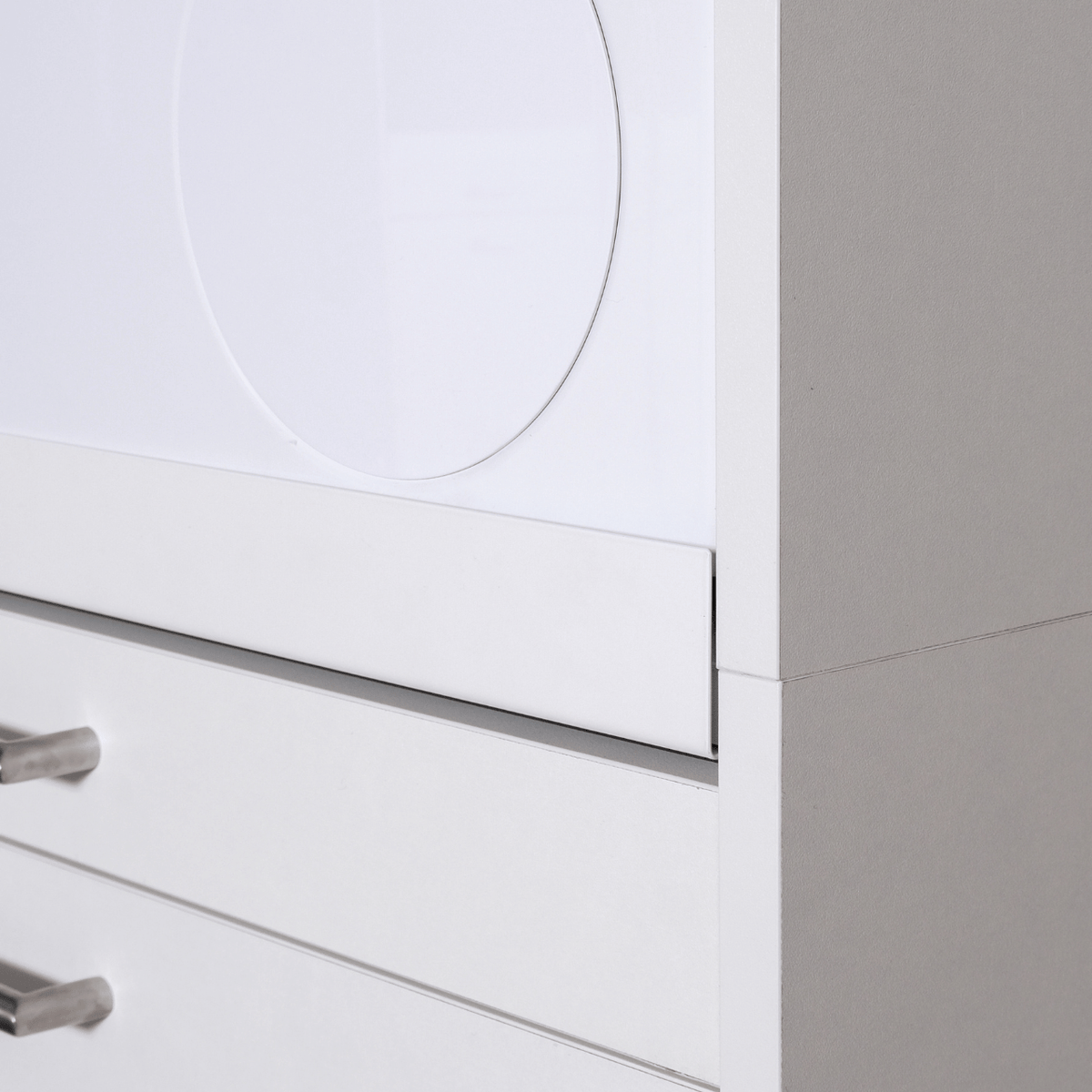 White modern cabinet corner with clean lines and metal handles on drawers.